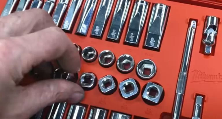 A person using sockets from an SAE and metric socket set